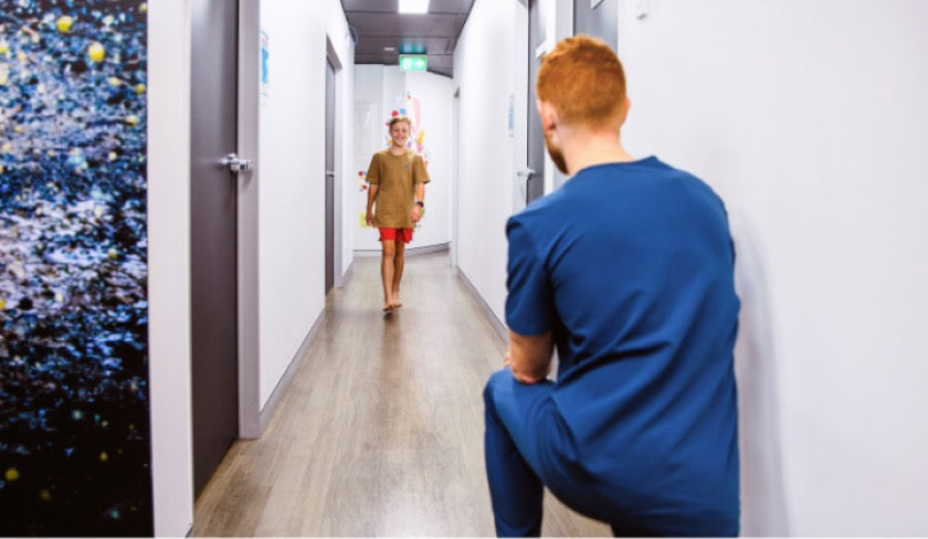 Male podiatrist checking patient's walking
