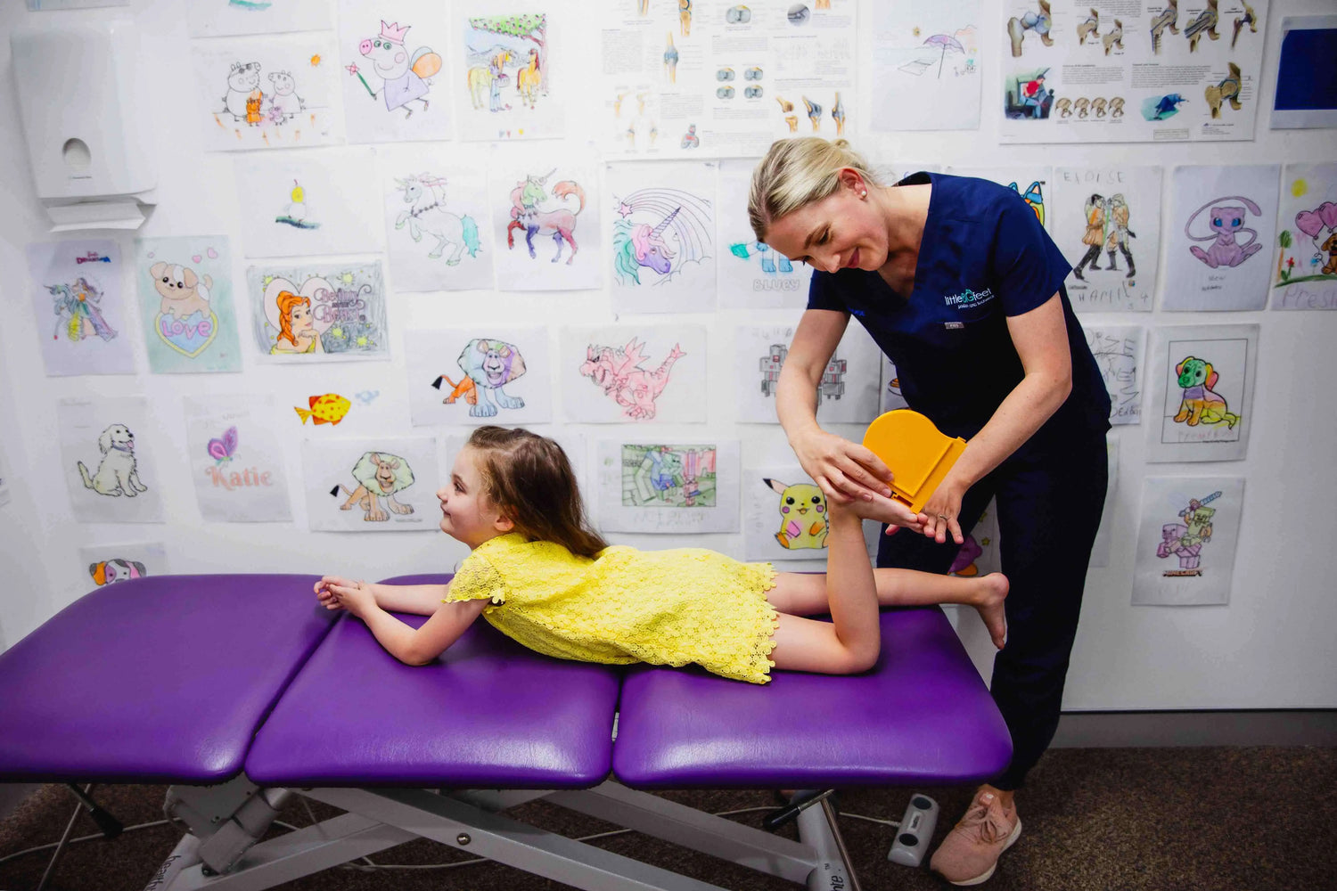 Lady podiatrist measuring girl's feet